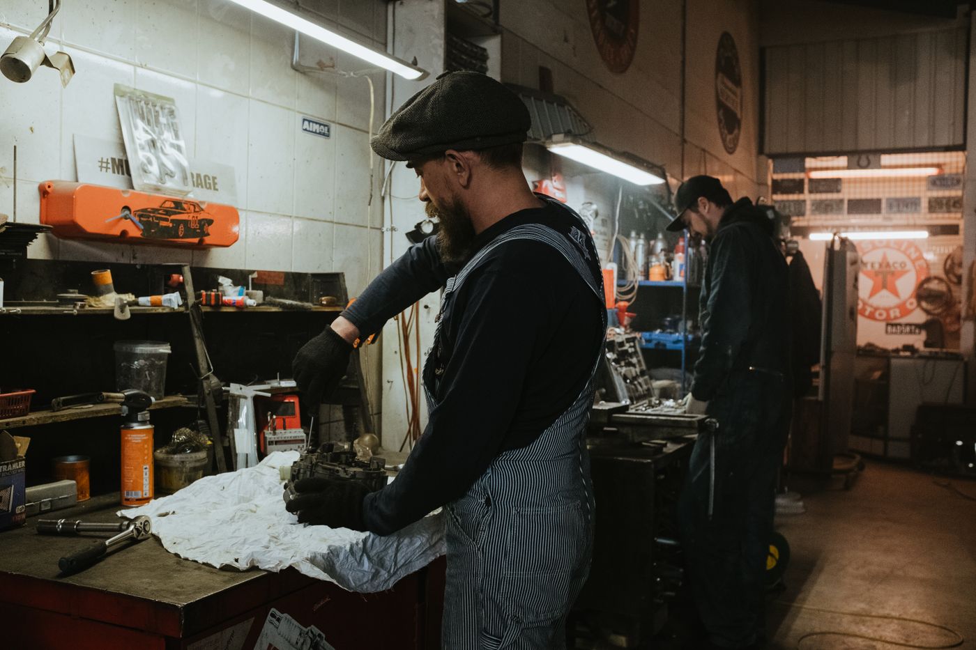 Mechanic working at a bench in a real, busy garage